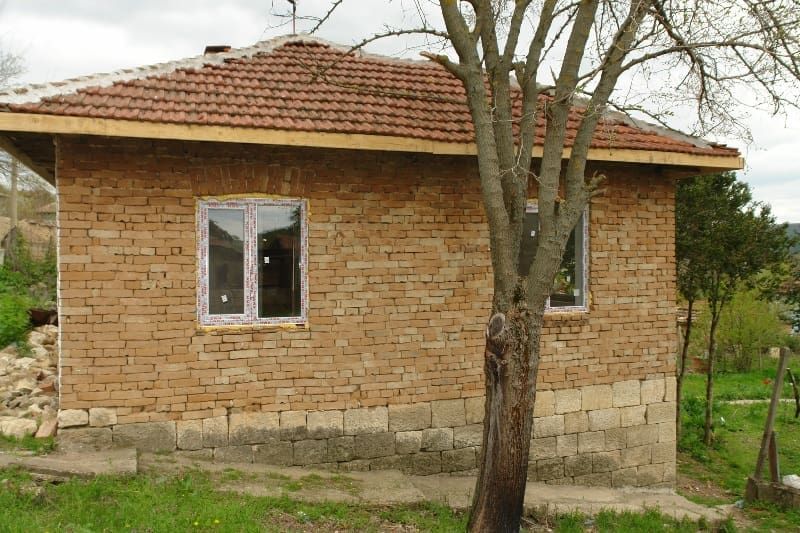 Property photo 2 of 54 Side Perspective Of The Rural House Showing Exposed Brick Walls And Two Newly Installed Windows.