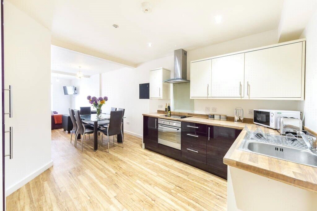 Property photo 3 of 15 Bright And Modern Kitchen Featuring Sleek Cabinetr...