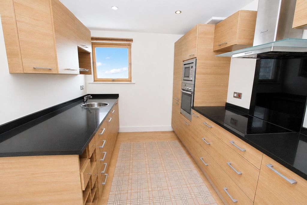 Property photo 3 of 10 Modern Kitchen With Sleek Black Worktops...