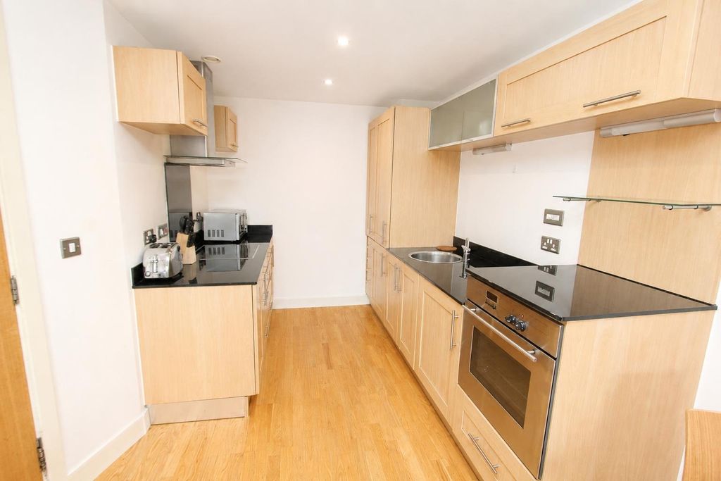 Property photo 3 of 7 Bright Modern Kitchen With Sleek Black Worktops...