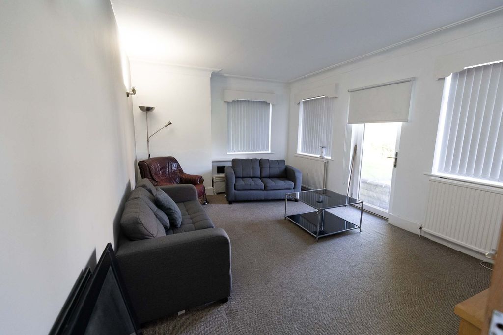 Property photo 2 of 7 Bright And Spacious Living Room Featuring Comforta...