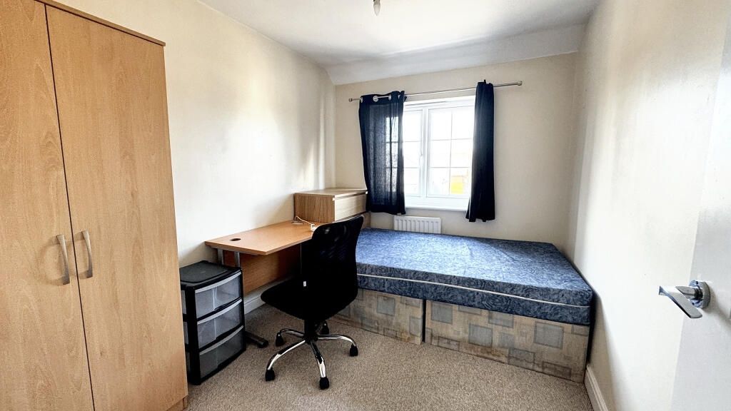 Property photo 2 of 6 Cozy Single Bedroom Featuring A Built-In Desk With...