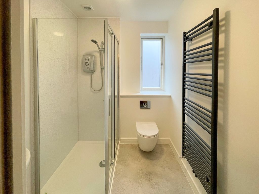 Property photo 2 of 13 A Modern Bathroom Featuring A Sleek Glass Shower, ...