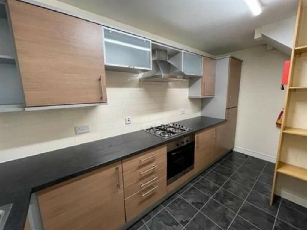 Property photo 3 of 8 Modern Kitchen Featuring Ample Storage With Wooden...
