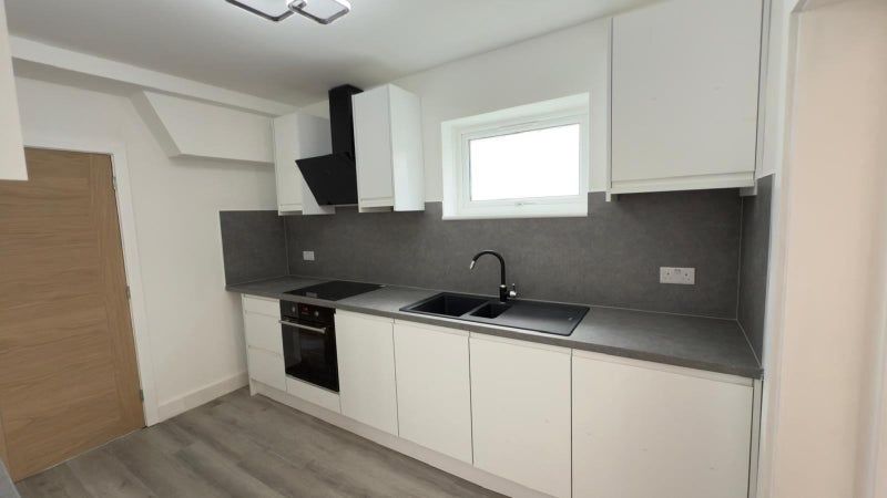 Property photo 1 of 4 A Modern And Sleek Kitchen Featuring Clean White c...