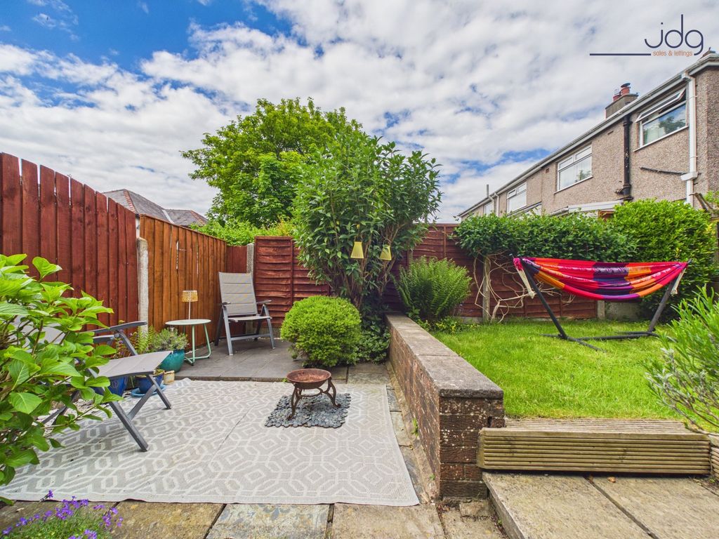 Property photo 2 of 15 Tiered Garden With A Mixture Of Flags, Decking And Lawn.