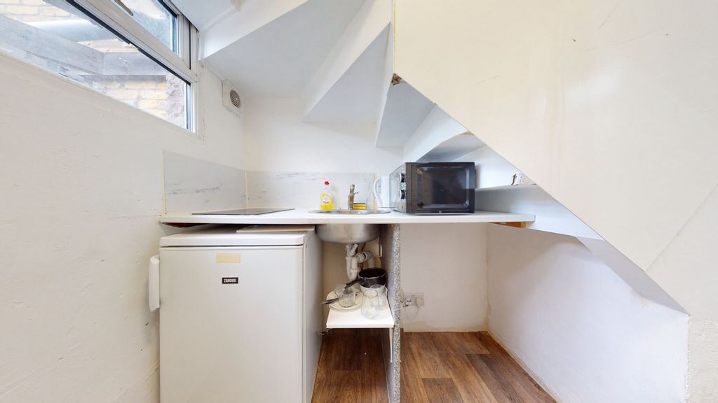 Property photo 2 of 7 Compact Kitchen Space Featuring A Small Fridge, mi...