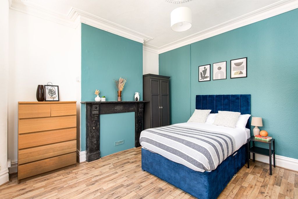 Property photo 2 of 14 Stylish Master Bedroom With Teal Feature Wall...