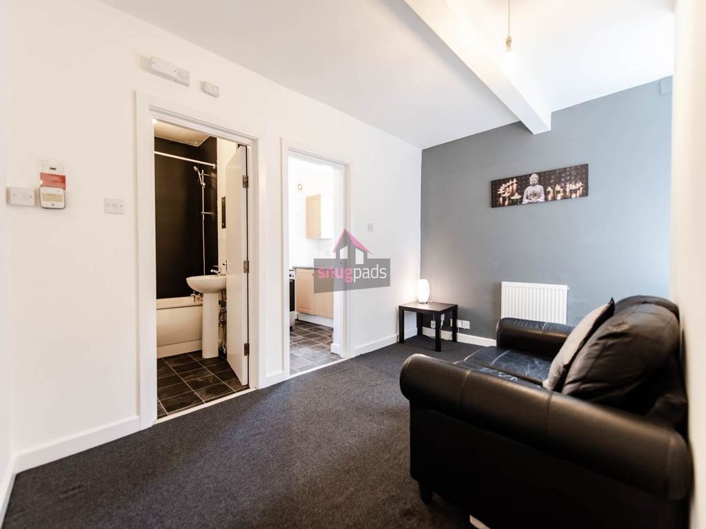 Property photo 2 of 6 A Cozy Living Room Featuring Modern Dark Leather S...