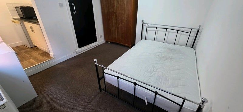 Property photo 1 of 12 Neat, Simply Furnished Bedroom Featuring A Metal-F...