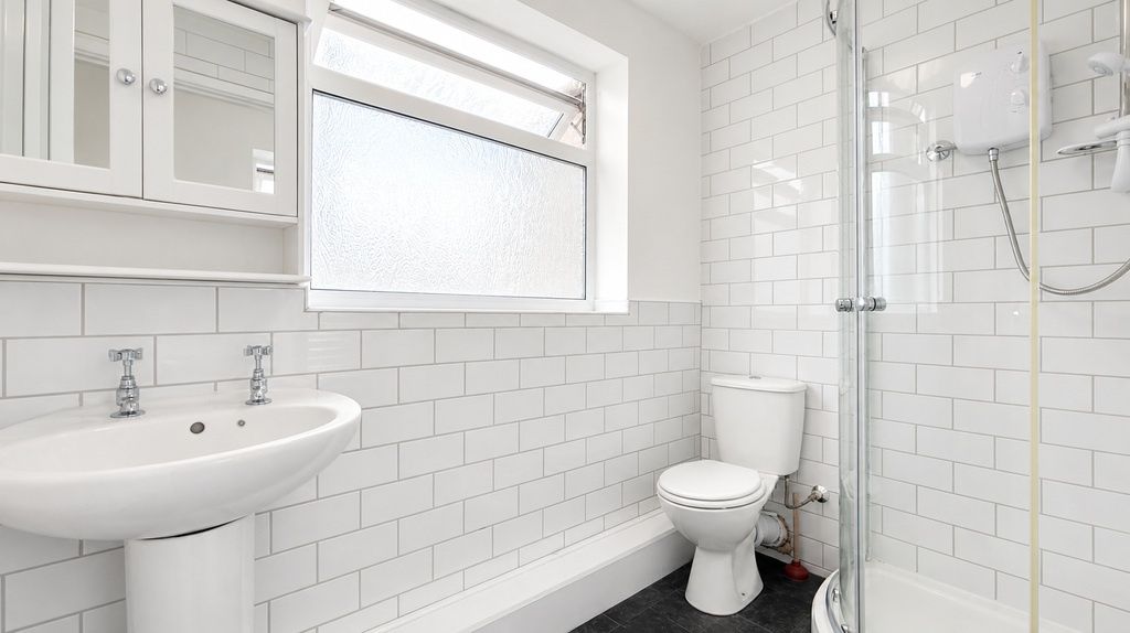 Property photo 2 of 4 Bright Modern Bathroom With Sleek White Tiling...