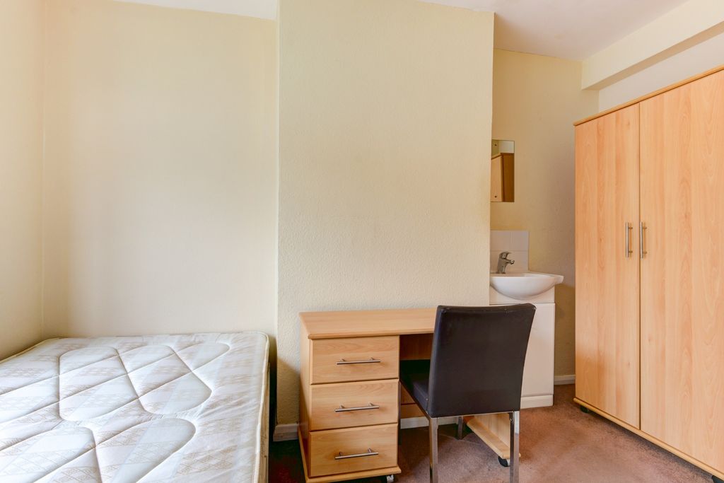 Property photo 3 of 17 A Cozy Student Bedroom Featuring A Bed, A Wooden d...