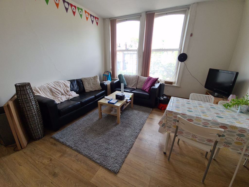 Property photo 1 of 10 A Bright And Welcoming Living Room Featuring A Lar...