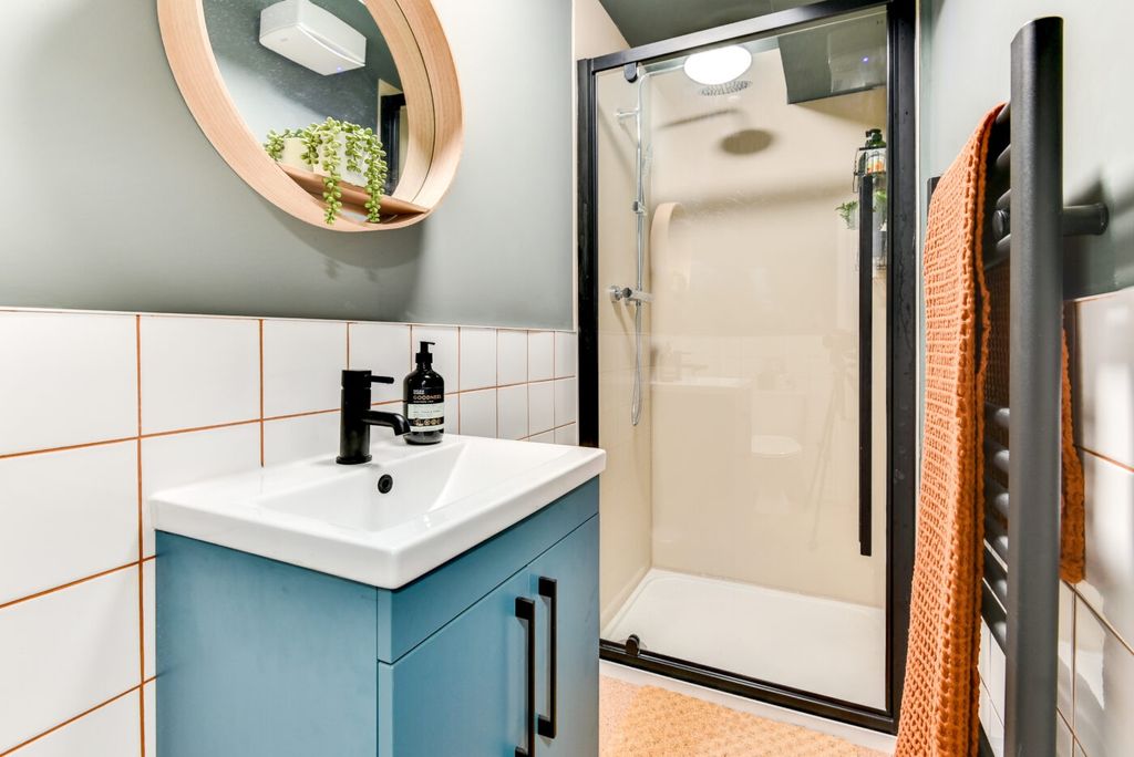 Property photo 2 of 5 Modern Tiled Bathroom With A Blue Vanity, Round Wo...