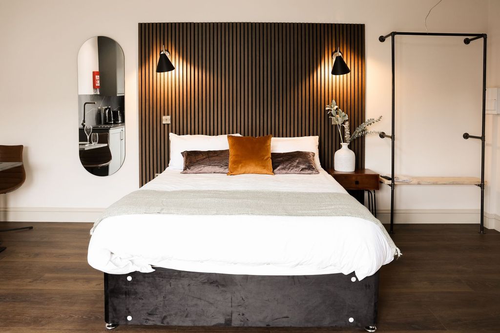 Property photo 3 of 18 Stylish Bedroom With Feature Wall And Warm Accents...