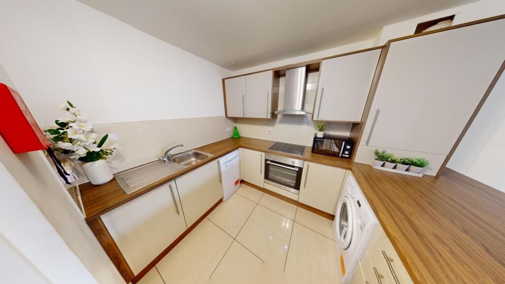 Property photo 3 of 13 Bright And Modern Kitchen Featuring Sleek Countert...