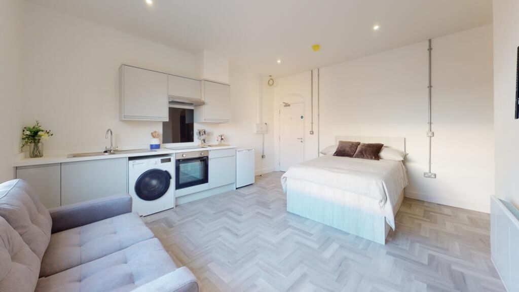 Property photo 2 of 5 A Spacious And Modern Living Area Featuring A Cozy...