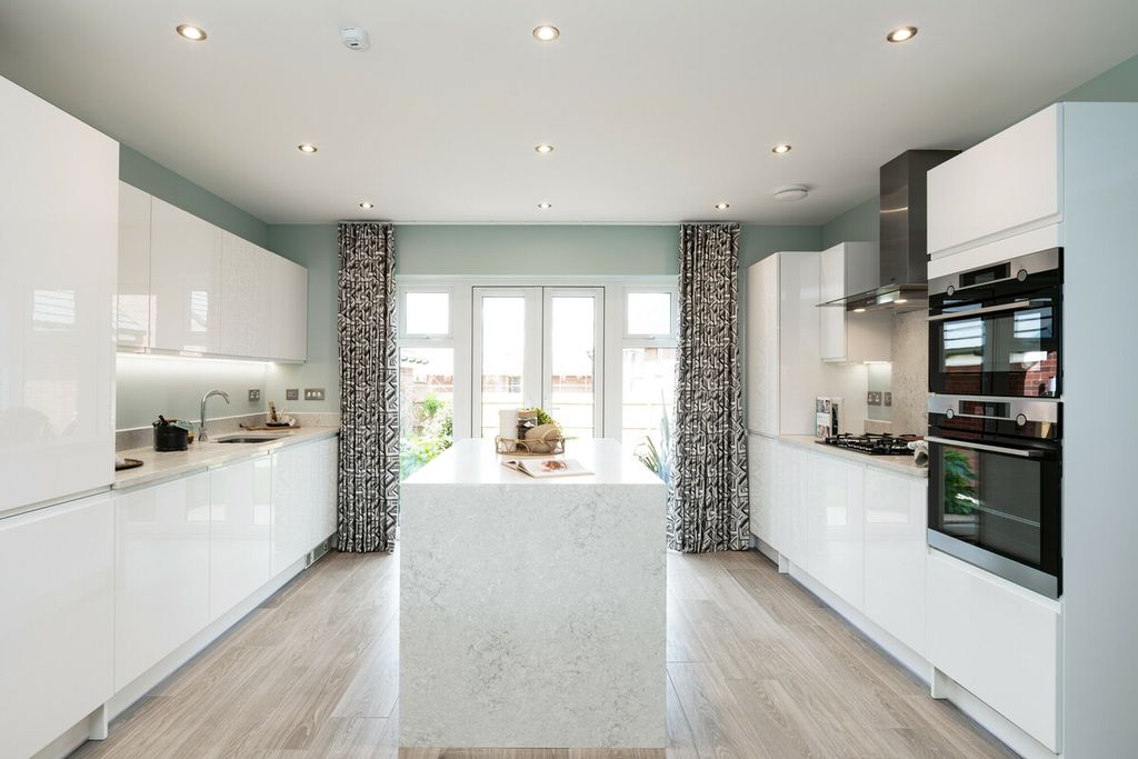 Property photo 3 of 10 A Modern White Kitchen With A Marble Island In The Foreground And Large Windows With Patterned Curta
