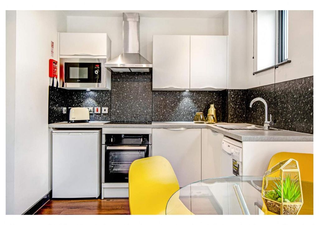 Property photo 2 of 3 Sleek Modern Kitchen With Stylish Dining Area...