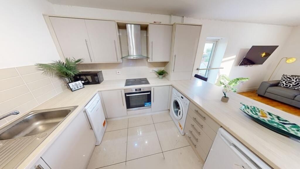Property photo 2 of 11 A Modern, Clean Kitchen Featuring Light Countertop...