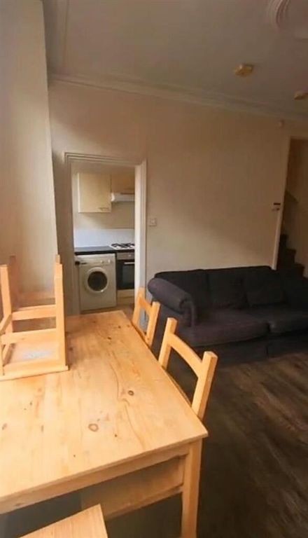 Property photo 2 of 9 A Cozy Living Room Featuring A Wooden Dining Table...