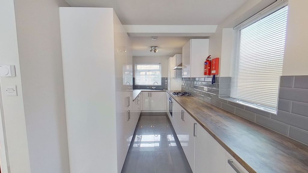 Property photo 1 of 12 Bright Modern Galley Kitchen With Glossy White Cab...
