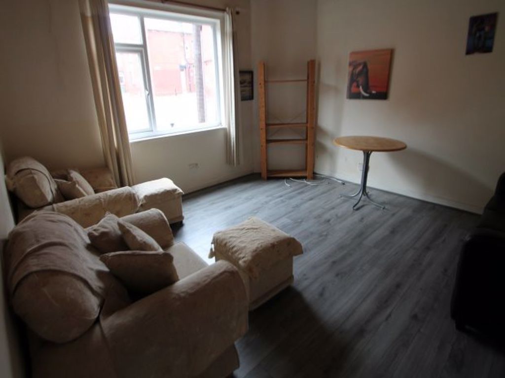 Property photo 3 of 12 A Cozy Living Room Featuring A Soft Armchair And S...