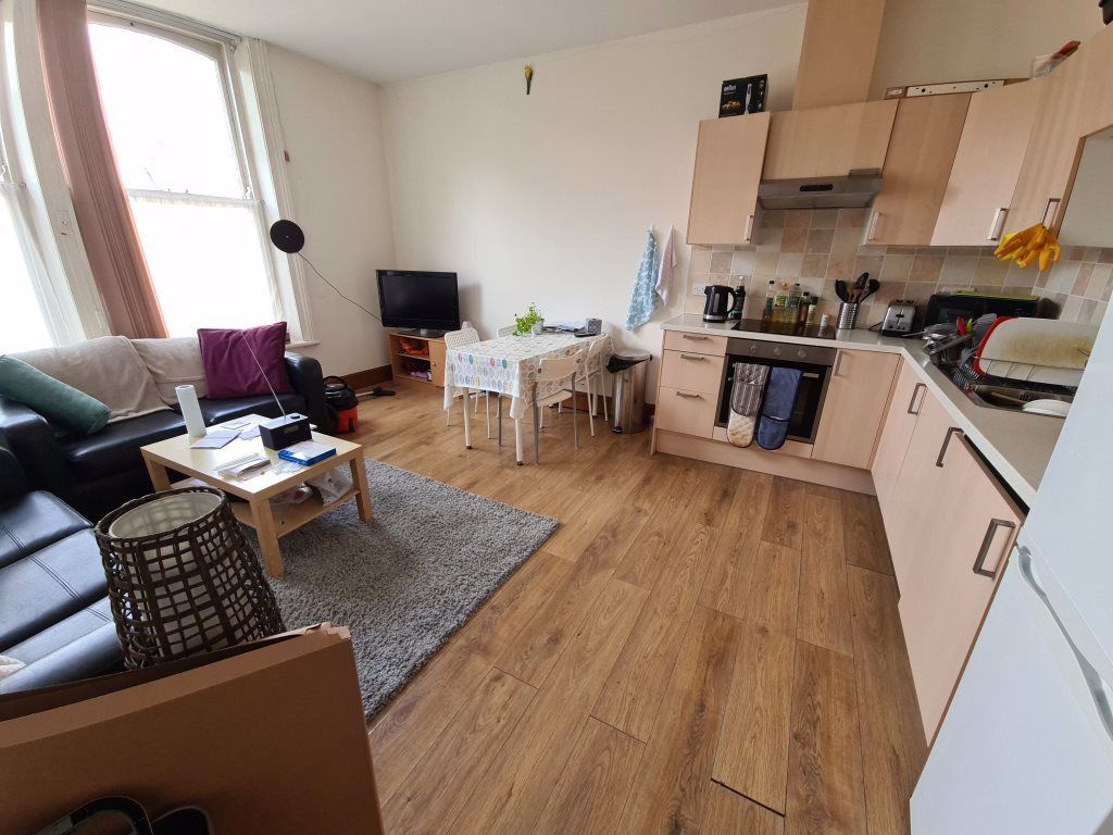 Property photo 3 of 10 Bright And Cozy Living Room Featuring A Modern Kit...