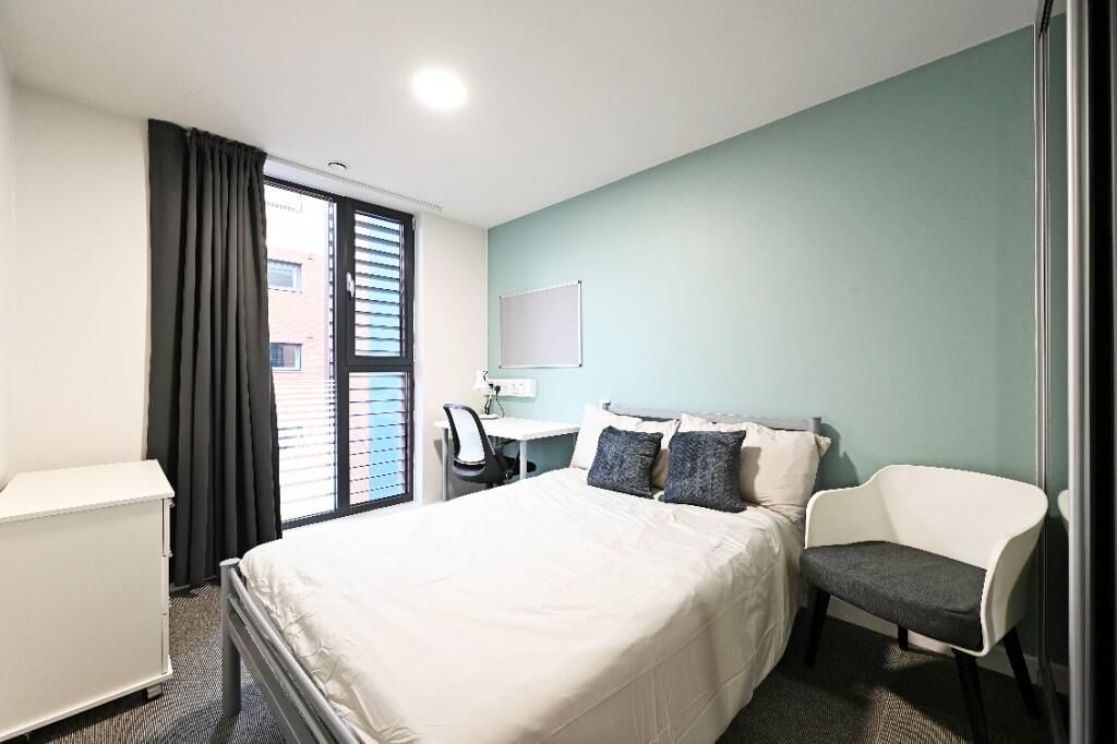 Property photo 1 of 12 A Modern, Well-Lit Double Bedroom Featuring A Comf...