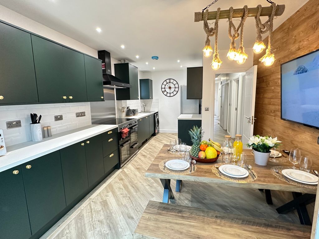 Property photo 2 of 4 Modern Kitchen Featuring Stylish Cabinetry, Ample ...