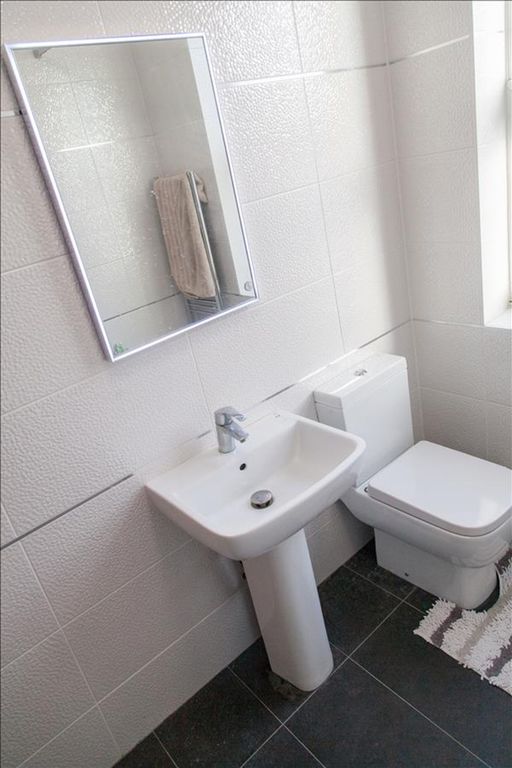 Property photo 2 of 19 A Well-Maintained Bathroom Featuring Modern Fixtur...