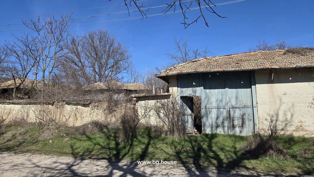 Property photo 2 of 67 Exterior View Of A Large Wooden Gate With Faded Blue Paint Set In A Surrounding Wall Under A Clear Blue Sky