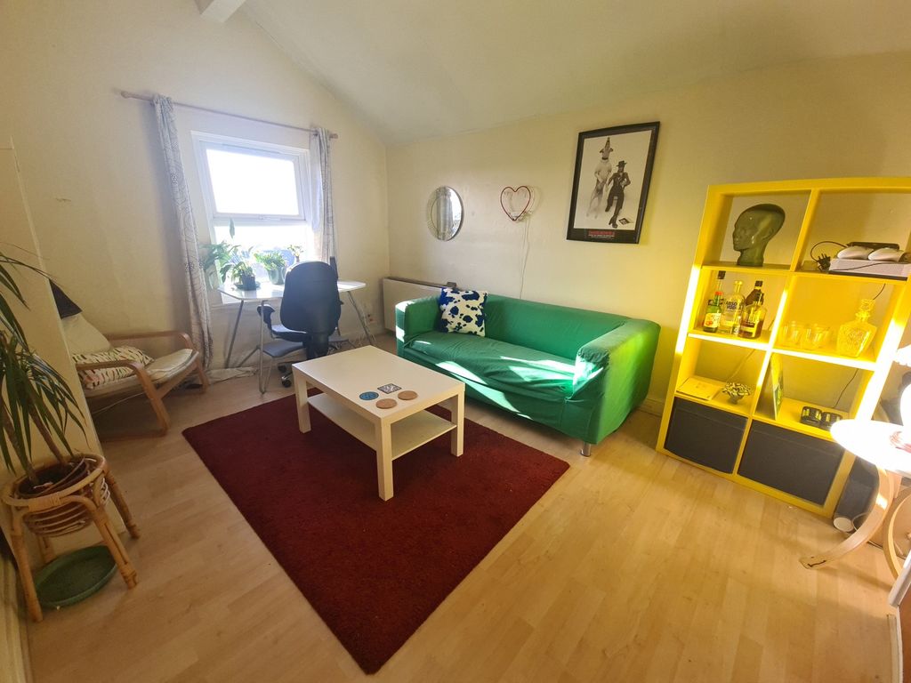 Property photo 2 of 5 A Bright And Welcoming Living Room Featuring A Com...
