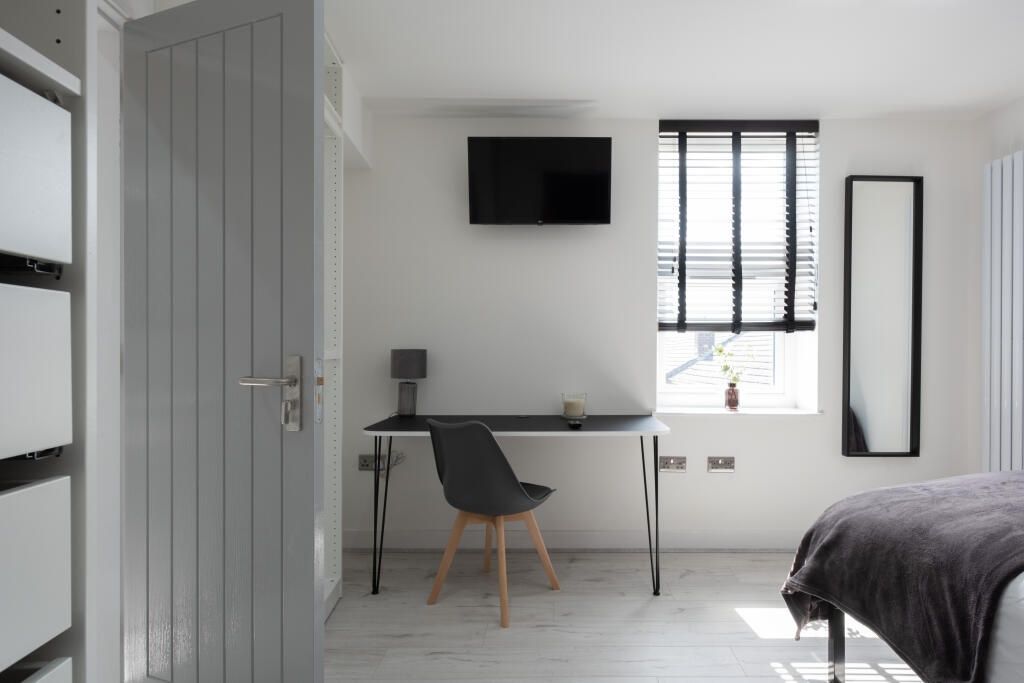 Property photo 1 of 14 Bright And Modern Master Bedroom Featuring A Styli...