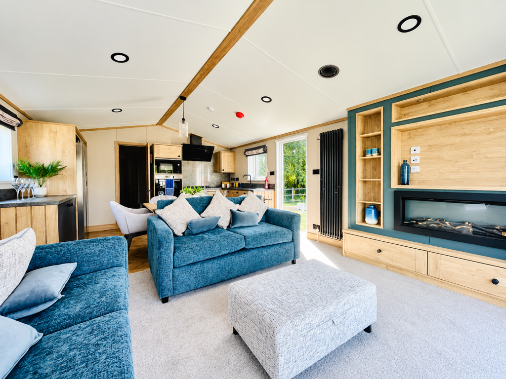 Property photo 1 of 5 Spacious Lounge With Blue Sofas, Feature Fireplace And Contemporary Furnishings
