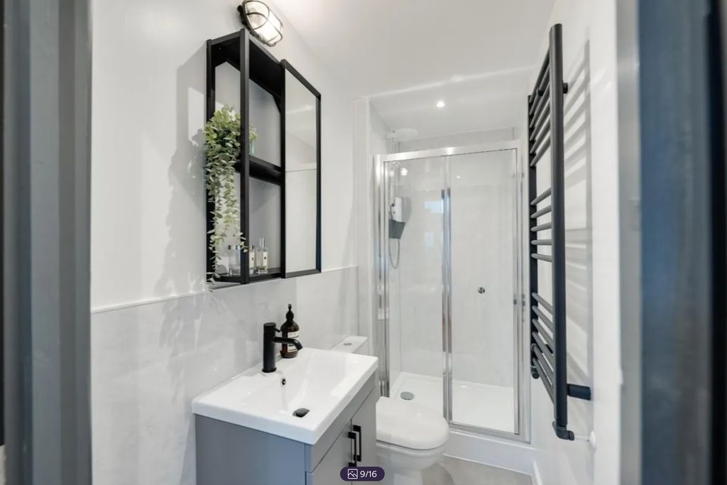 Property photo 3 of 16 A Modern And Stylish Bathroom Featuring A Sleek De...
