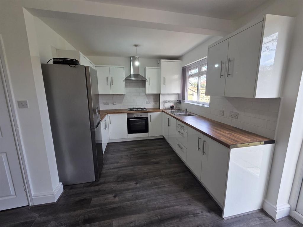Property photo 3 of 12 Modern Kitchen With Sleek White Cabinetry...