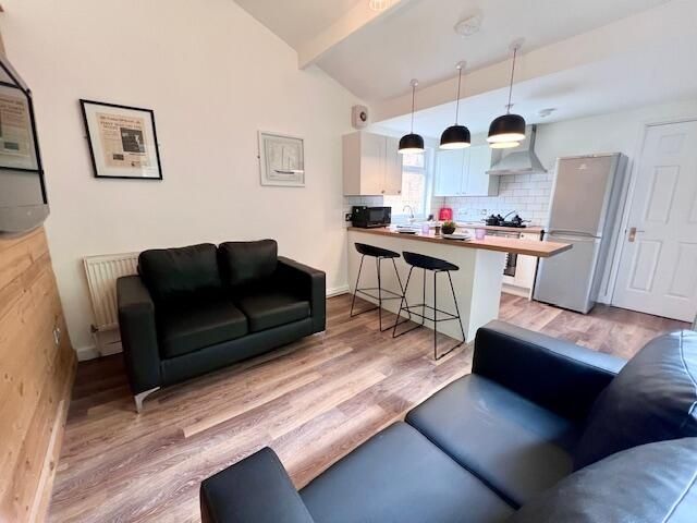 Property photo 3 of 9 Bright And Modern Living Room Featuring Comfortabl...