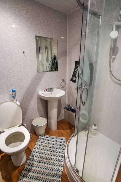 Property photo 3 of 4 A Clean And Modern Bathroom Featuring A Corner Sho...