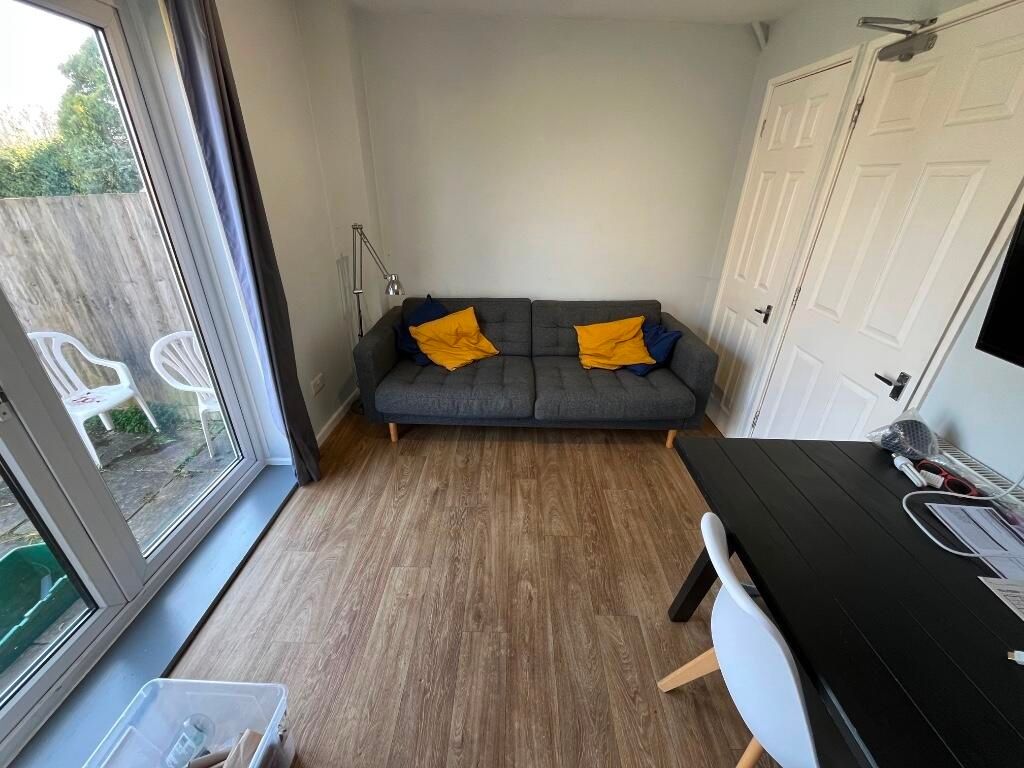 Property photo 3 of 14 A Bright And Tidy Living Room Featuring Large Glas...