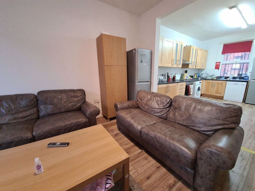 Property photo 1 of 17 A Spacious And Inviting Living Room Featuring Comf...