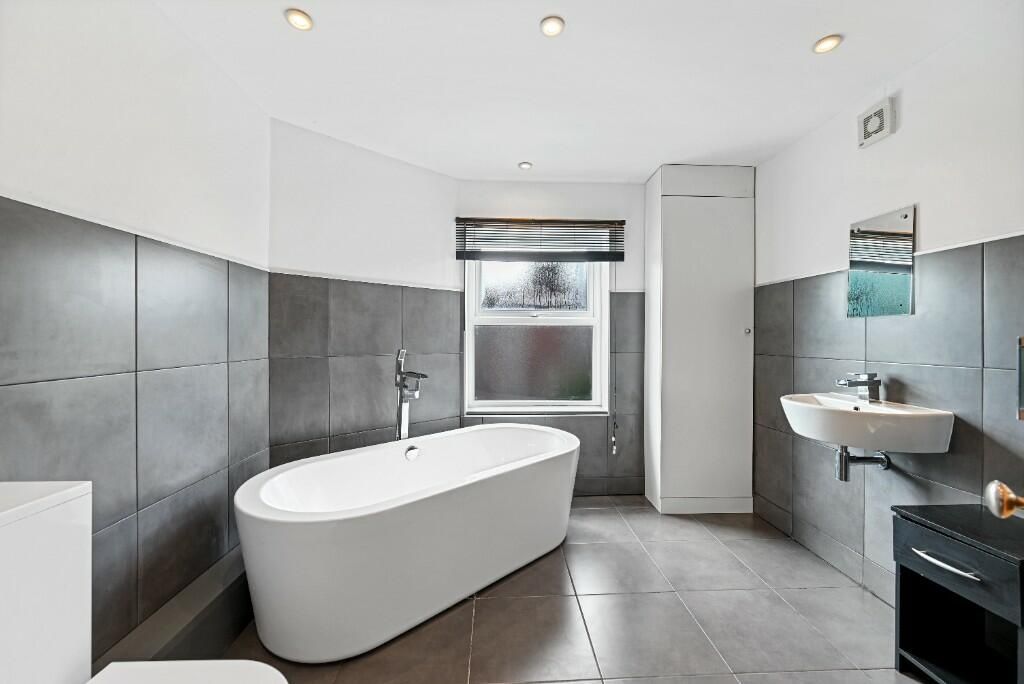 Property photo 2 of 14 A Modern And Stylish Bathroom Featuring A Freestan...