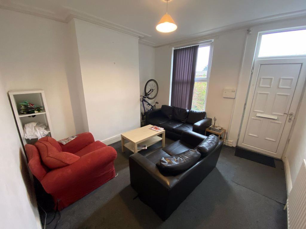 Property photo 1 of 18 A Bright And Welcoming Living Room Featuring A Bla...