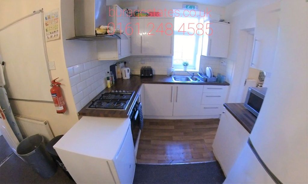 Property photo 3 of 9 Bright, Modern Galley-Style Kitchen With White Cab...