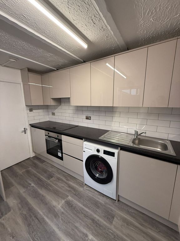 Property photo 1 of 17 This Modern Kitchen Features Sleek Cabinetry And A...