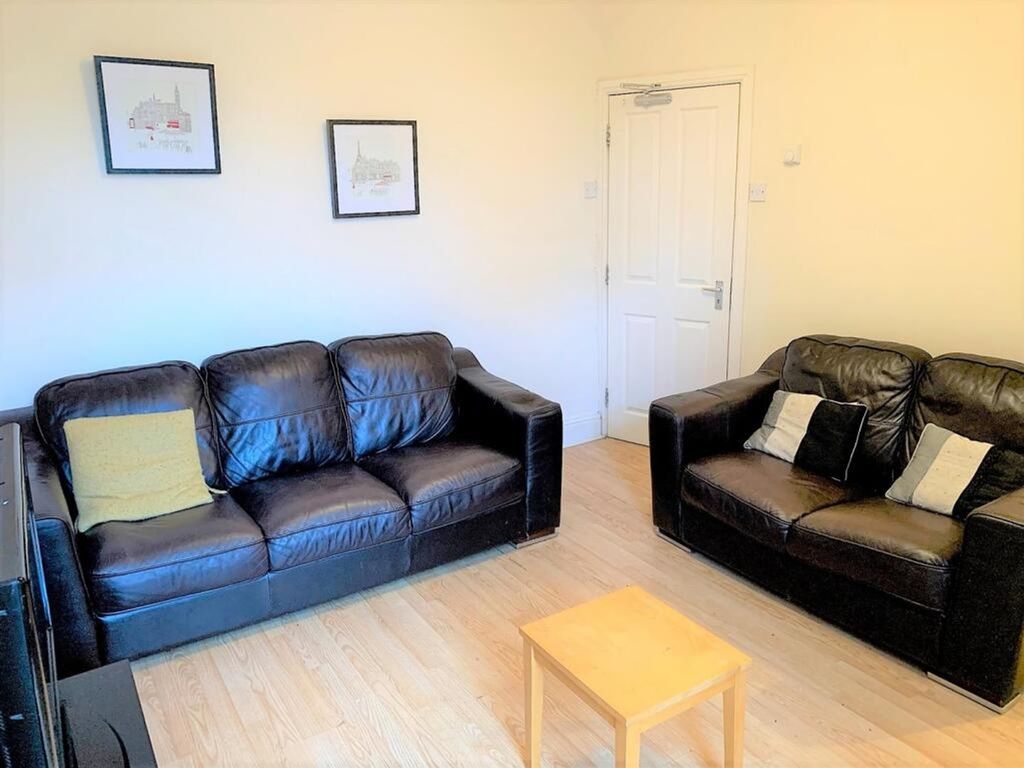 Property photo 2 of 12 A Cozy And Inviting Living Room Featuring Comforta...