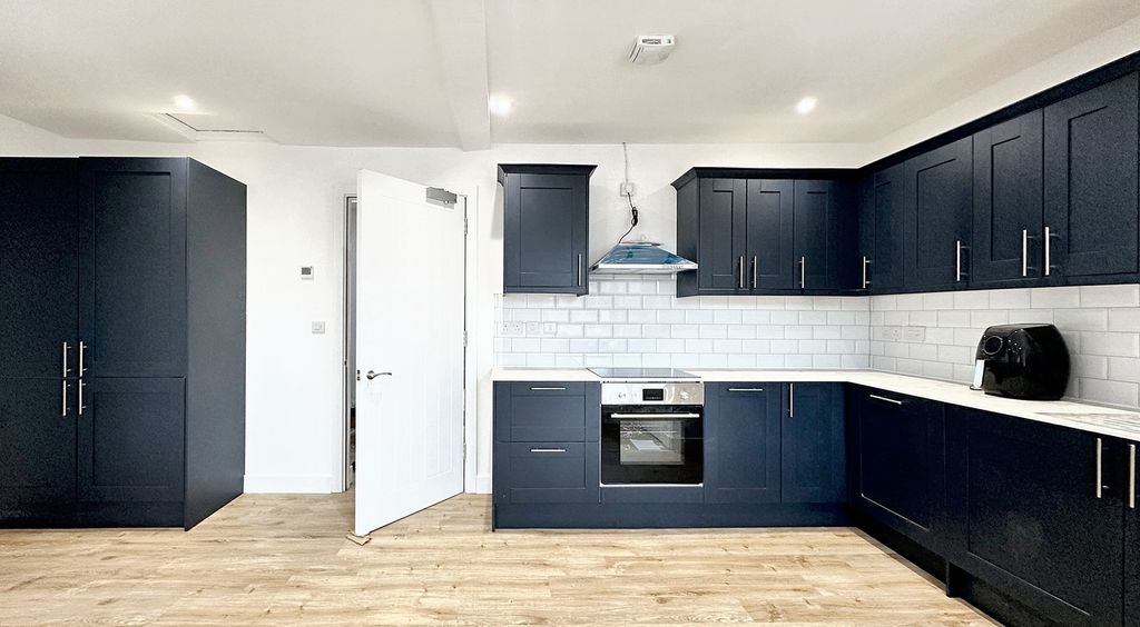 Property photo 1 of 11 This Modern Kitchen Features Sleek Navy Cabinetry,...