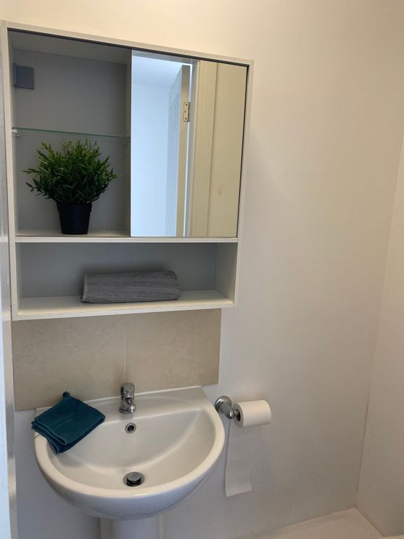 Property photo 2 of 21 A Modern Bathroom Featuring A Sleek Sink And Styli...