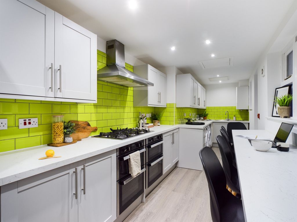 Property photo 3 of 4 A Modern And Spacious Kitchen Featuring Vibrant Gr...