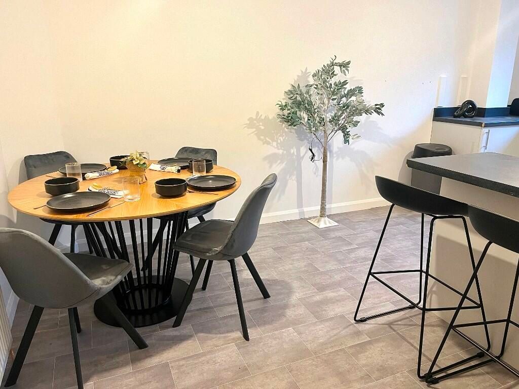 Property photo 1 of 8 A Modern Living Room Area Featuring A Stylish Roun...